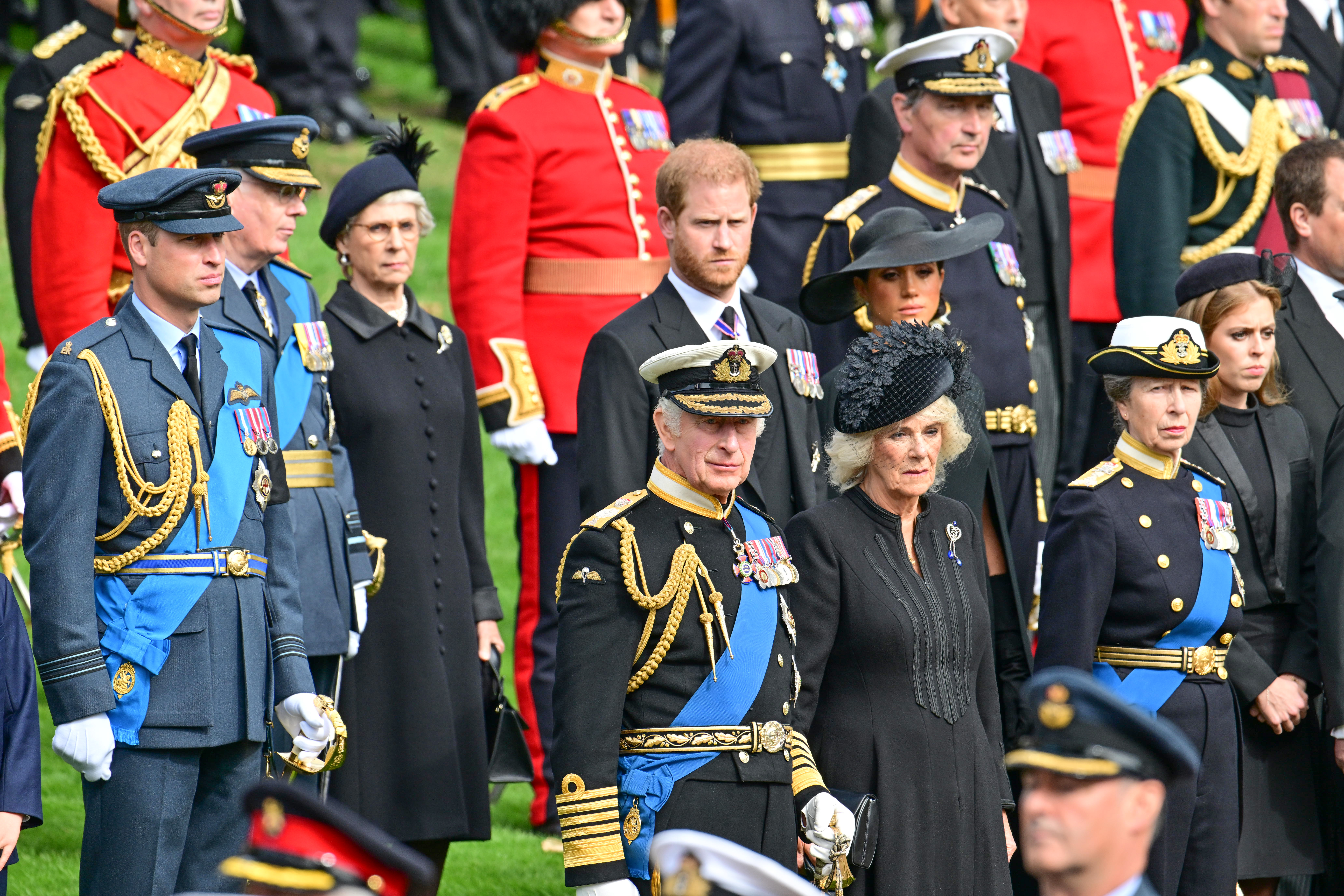 Prince William, Prince of Wales, Prince Harry, Duke of Sussex, Meghan, Duchess of Sussex, King Charles III, Camilla, Queen Consort, Princess Anne, Princess Royal and Princess Beatrice observe the coffin of Queen Elizabeth II as it is transferred from the gun carriage to the hearse at Wellington Arch following the State Funeral of Queen Elizabeth II at Westminster Abbey